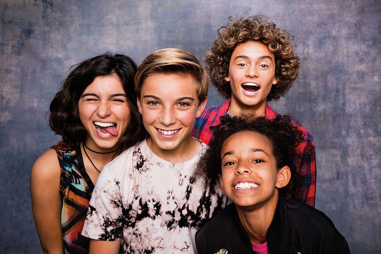 Teens having fun together in a photoboothjpg Teens having fun and boosting their confidence with Invisalign in a photobooth