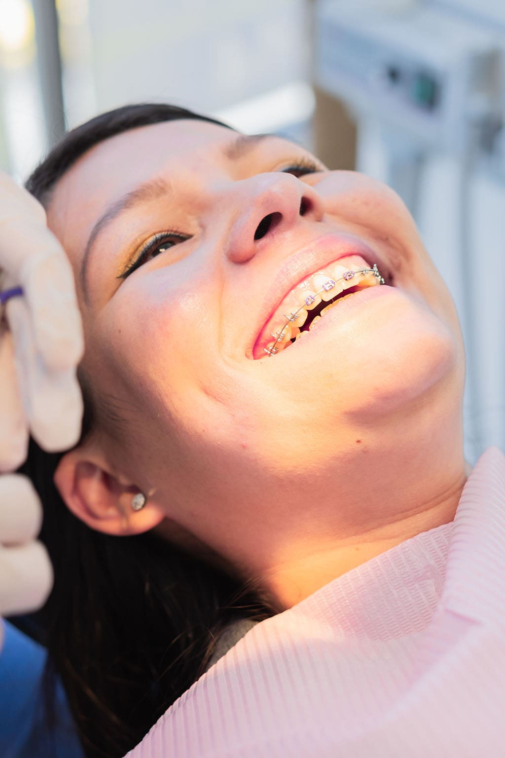 smiling teen girl with braces at her orthodontist appointment Happy teenage girl smiling with braces after successful orthodontic appointment