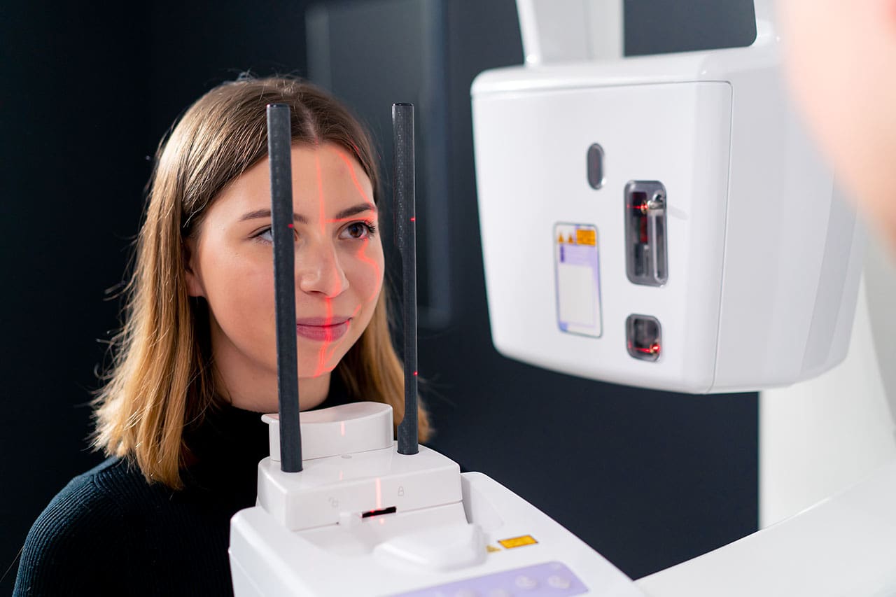 woman having 3D dental imaging taken Advanced 3D dental imaging technology for precise orthodontic care. Refer a friend and help them achieve a beautiful smile.