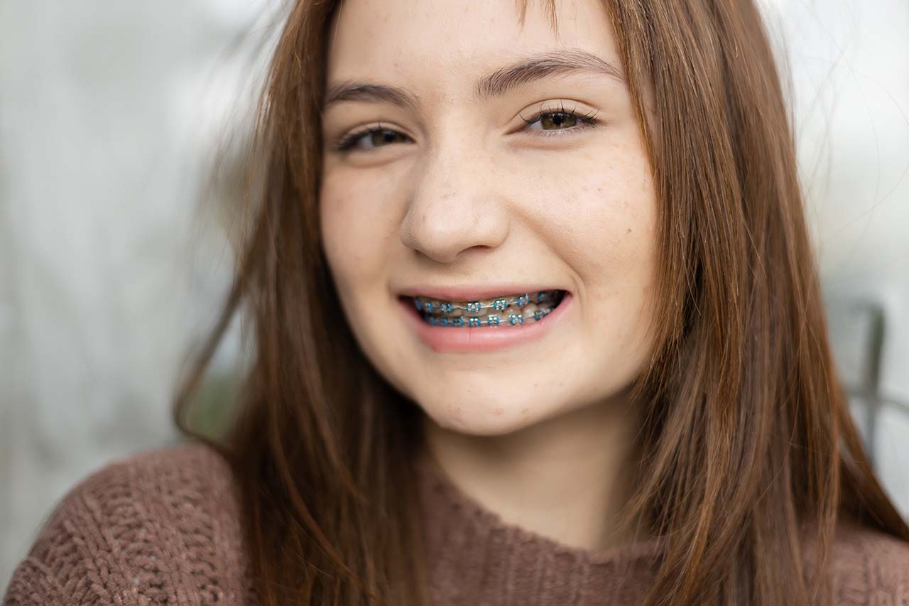 Confident smiling teen girl shows off her braces in Shorewood Ferri Orthodontics transforms smiles and inspires confidence